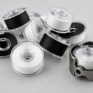 Prewound white and black embroidery bobbins